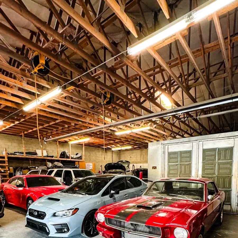 Vehicles inside the GAMAX Auto Body repair shop in Murray, Utah